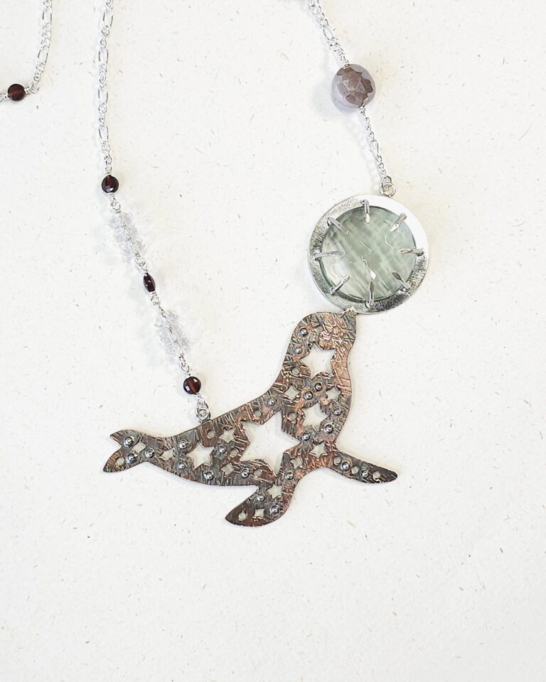 star-splashed seal pendant with faceted aqua obsidian gemstone necklace