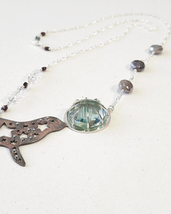 star-splashed seal pendant with faceted aqua obsidian gemstone necklace