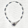 meteor inspired handmade necklace with silver wire-wrapped peacock ore and azurite beads
